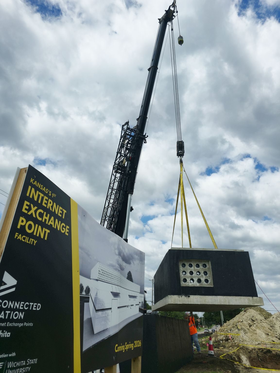 A crane sets a fiber vault during construction of IXP.US Wichita